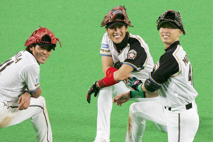 投手交代の合間に笑顔を見せる日本ハム・稲葉篤紀、新庄剛志、森本稀哲（左から）【写真：共同通信社】