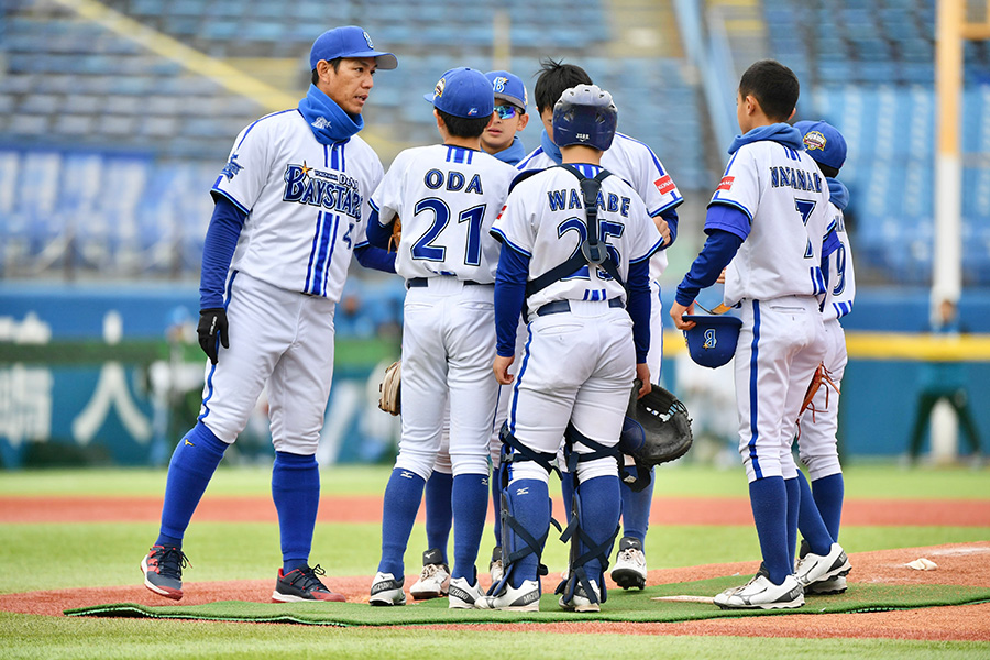 DeNAジュニアを率いた荒波翔氏（左端）【写真：小林靖】