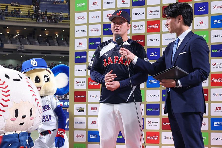 ヒーローインタビューを受ける牧秀悟（中央）と映り込むドアラ【写真：加治屋友輝】